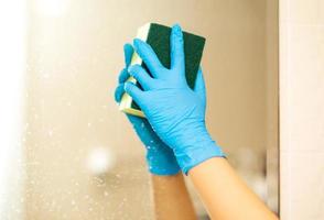 Hygiene. Cleaning Hands. Washing bathroom with sponge and alcohol spray or soap over sink in bathroom, closeup. Covid19. Coronavirus. photo