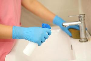 Hygiene. Cleaning Hands. Washing hands with alcohol gel or soap. Young woman washing hands with soap over sink in bathroom, closeup. Covid19. Coronavirus. photo