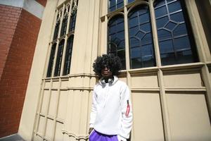 Afro American man having fun walking in city center - Happy young guy enjoying time a sunset outdoor - Millennial generation lifestyle and positive people attitude concept photo