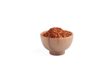 dried chili peppers in a wooden cup on a white background photo