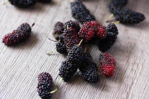 fresh mulberries on wooden background photo