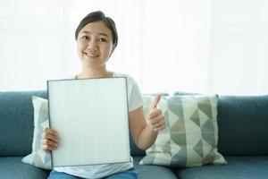 Asian young woman showing an used and the new air purifier filer, comparing between used dirty and new air filter. photo