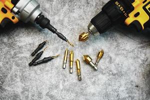 Metric Woodworking Countersink Drill Bit 90 Degree Single Flute Edge Chamfer with Power drill or Cordless screwdriver on desk in workshop.selective focus photo