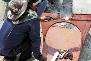 Welder working  arc welding machine at construction site photo