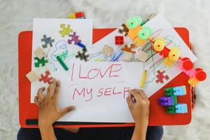 Autistic childrens writings I Love My Self. Childhood traumatic experience, psychology, psychological, asperger syndrome, asperger's disorder, autistic, autism concept photo