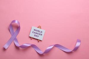 Purple Ribbon On Pink For Alzheimer's Disease, Pancreatic Cancer, Epilepsy Awareness, World Cancer Day photo