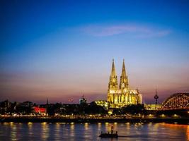 HDR St Peter Cathedral and Hohenzollern Bridge over river Rhine photo