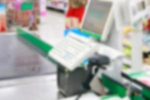 Empty cash desk with payment terminal blurred background photo