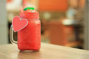 Strawberry smoothie with fresh berries on wood table photo