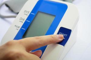 Digital Blood Pressure Monitor on white background photo