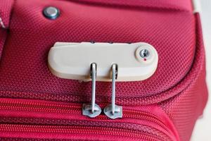 combination lock on red suitcase travel bag photo