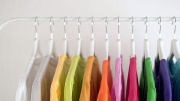 Close up of Colorful t-shirts on hangers video