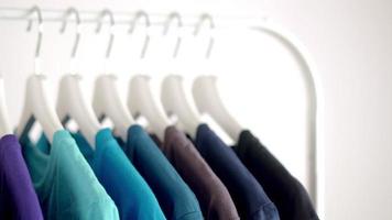 Close up of Colorful t-shirts on hangers video