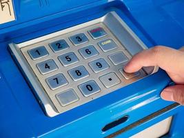 woman using ATM machine to withdraw money photo