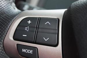 Audio control buttons on the steering wheel of a modern car photo