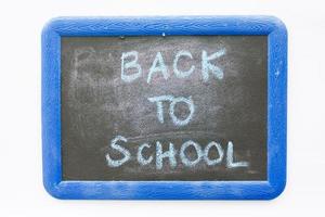 back to school text on chalkboard isolated on white background photo