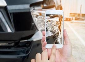 female hold mobile smartphone photographing car accident photo