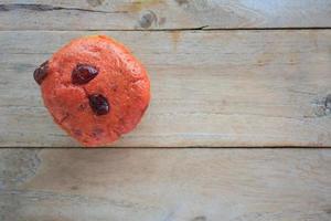 cranberry cup cake on wood background photo