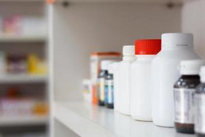 bottles on pharmacy store shelf photo