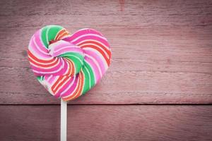 colorful heart lollipop on wood background