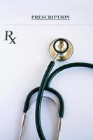 Prescription form lying on table with stethoscope photo