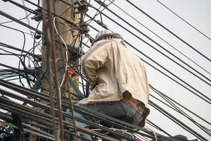 Electrician on electric poles photo