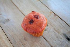 cranberry cup cake on wood background photo