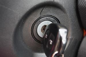 car key inserted into the lock of ignition of the car photo