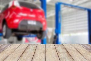 Wood table top with blur car service centre background photo