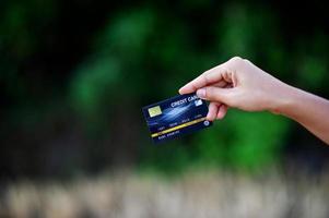 Hand and credit cards, online business operations, and cashless purchases Credit card ideas for shopping photo