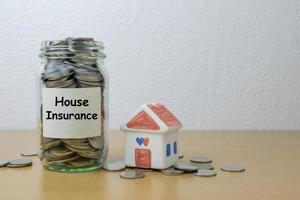 Money saving for house Insurance in the glass bottle photo