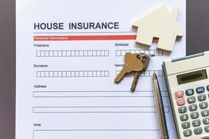 House insurance form with model and policy document photo