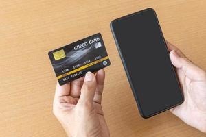 Man holding credit card and smartphone. On-line shopping on the internet using a smartphone photo