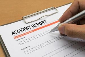 man signing a accident report form photo
