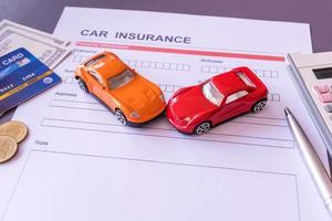 Car insurance form with model and policy document photo