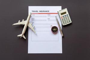 Travel  insurance form with model and policy document photo