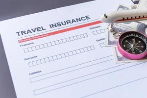 Travel  insurance form with model and policy document photo