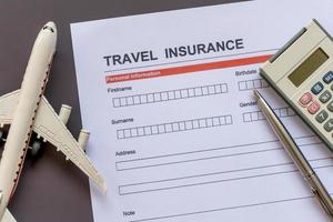 Travel  insurance form with model and policy document photo