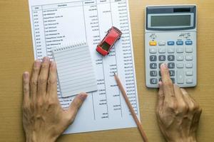 Man planning monthly budget, Finance about car concept photo