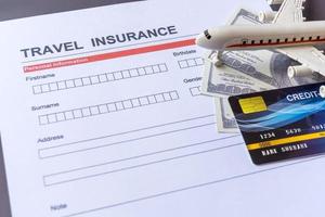 Travel  insurance form with model and policy document photo