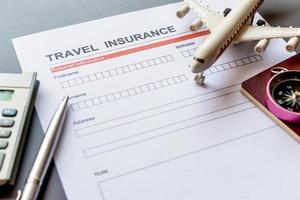 Travel  insurance form with model and policy document photo