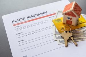 House insurance form with model and policy document photo