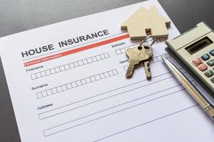 House insurance form with model and policy document photo