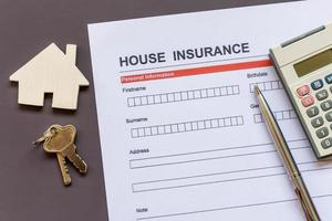 House insurance form with model and policy document photo