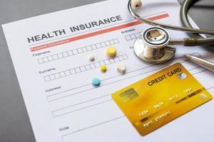 Health insurance form with model and policy document photo