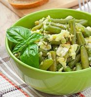 String beans with eggs in bowl. photo
