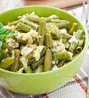 String beans with eggs in bowl. photo