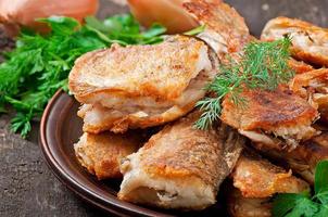 Fish dish - fried fish and herbs photo