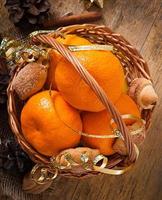 Tangerines and spices on a wooden background photo