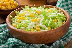 Chinese cabbage salad with sweet corn in a wooden bowl photo